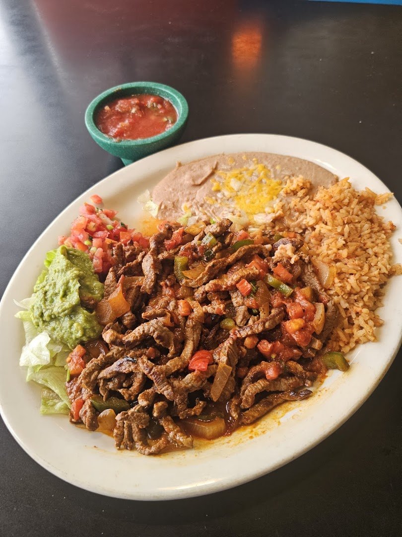 Chips and salsa beside a hearty entrée.